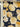 A printed pure wool fabric featuring yellow flowers on a navy background, branded 'Emanuel Ungaro' on the selvedge.