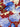 Close-up of a pure wool fabric with blue and white flowers on a red background