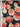 Floral fabric with pink and red flowers on a dark navy background, featuring the brand 'Emanuel Ungaro' on the selvedge.